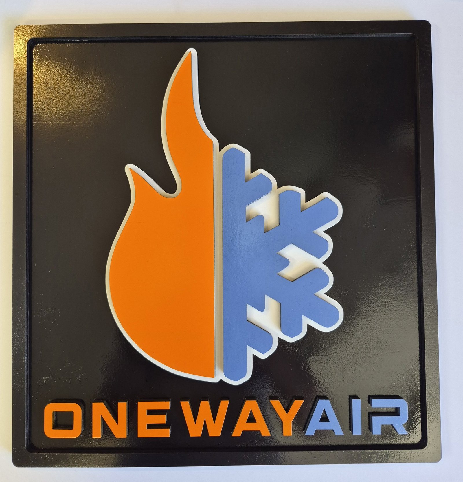 One Way Air business logo with an orange flame, blue snowflake and raised lettering.