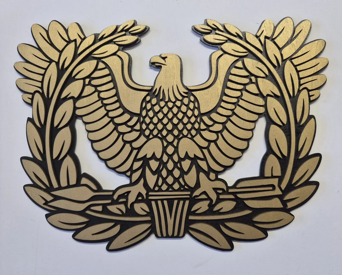 Natural wood eagle and laurel emblem with layered feather and branch details.