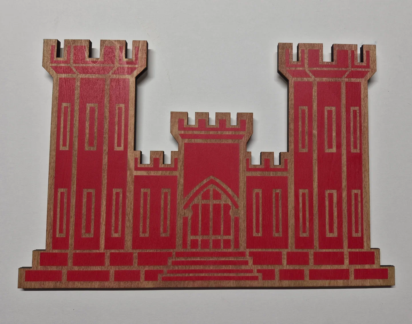 Red engineer castle emblem with layered stonework and three towers.