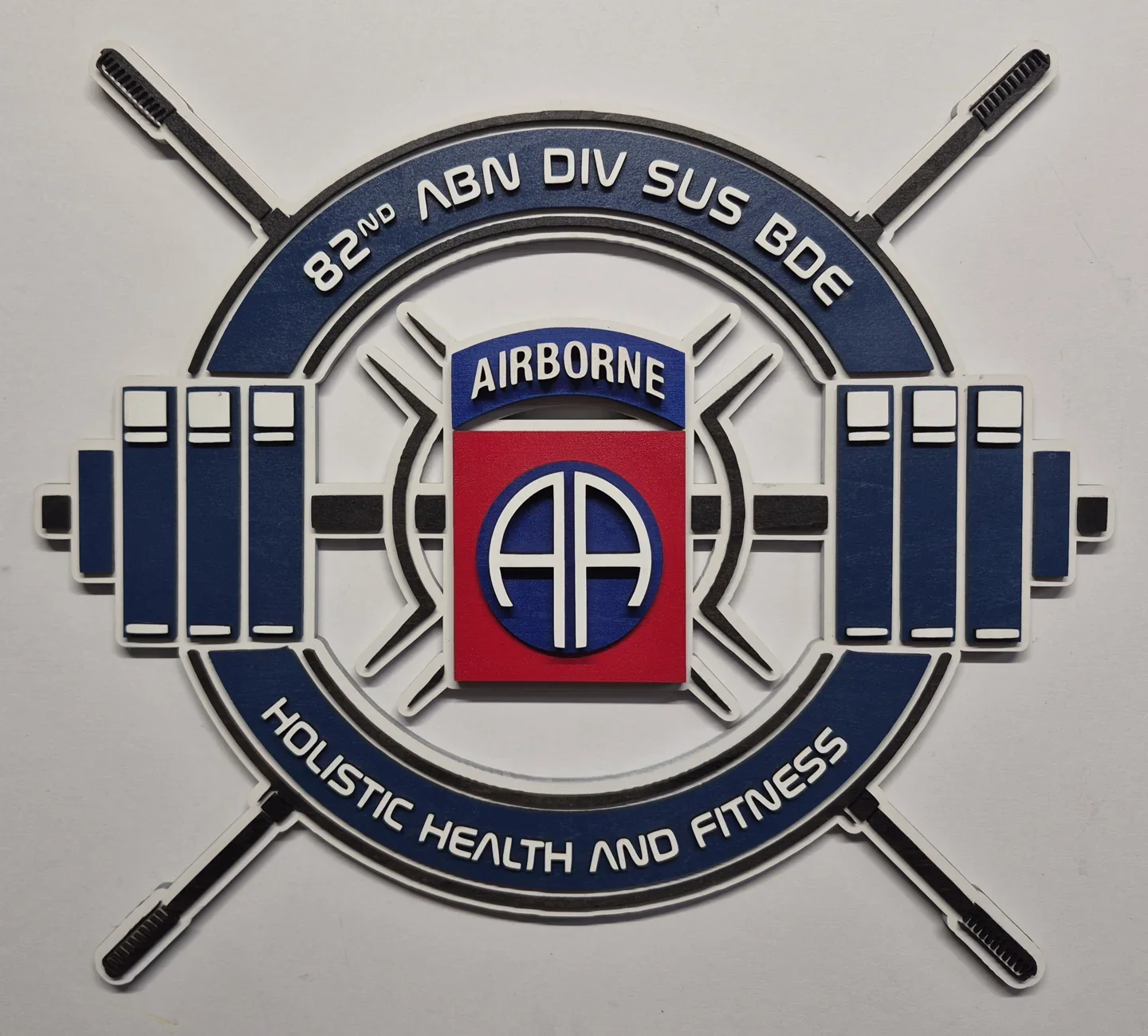 Round 82nd Airborne strength and fitness emblem with a barbell and crossed bars.