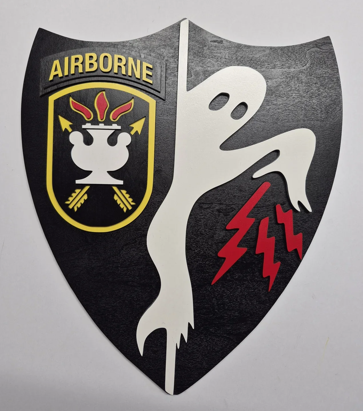 Airborne shield with a skull, red lightning bolts and a smaller inset unit crest.