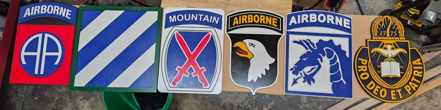 Collection of colorful dimensional military insignia arranged in a row.