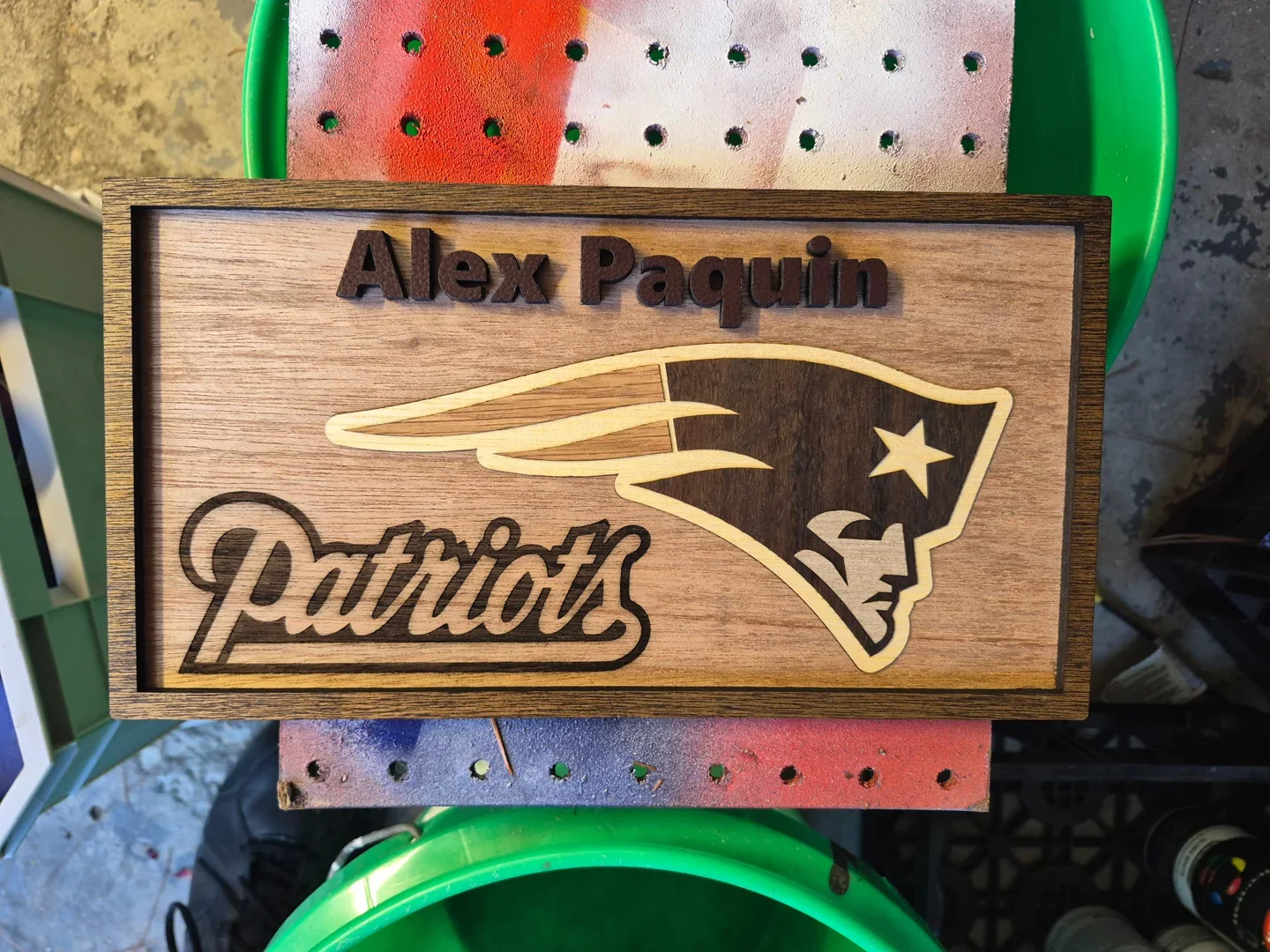 Personalized football fan sign with a team emblem and raised lettering on wood.