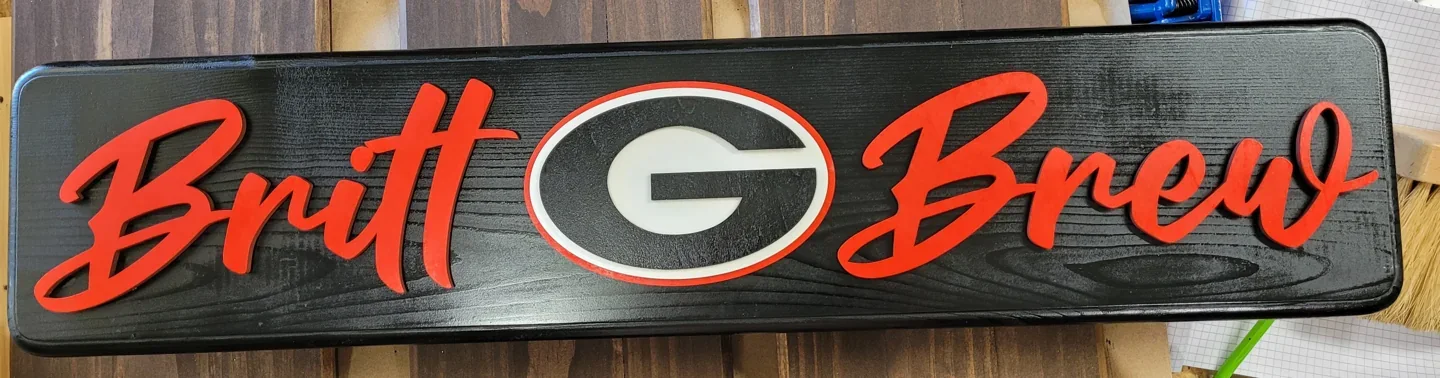 Personalized team and brewery sign with red script lettering on a wood background.